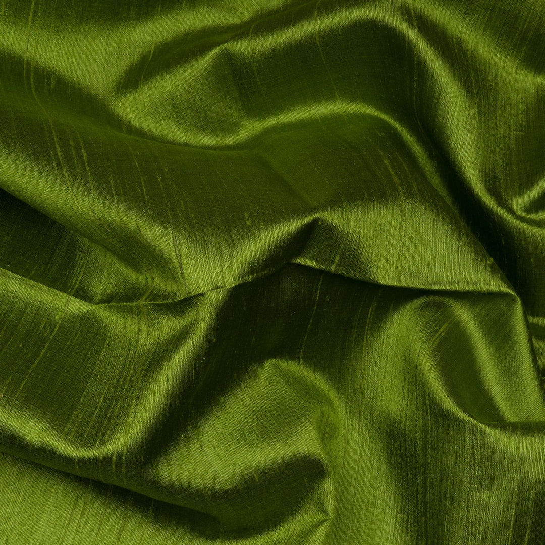 Blouse closeup of a Green Dupion silk saree with pink border and gold zari pallu.