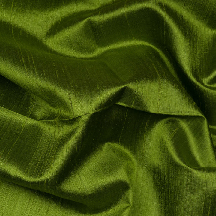 Blouse closeup of a Green Dupion silk saree with pink border and gold zari pallu.