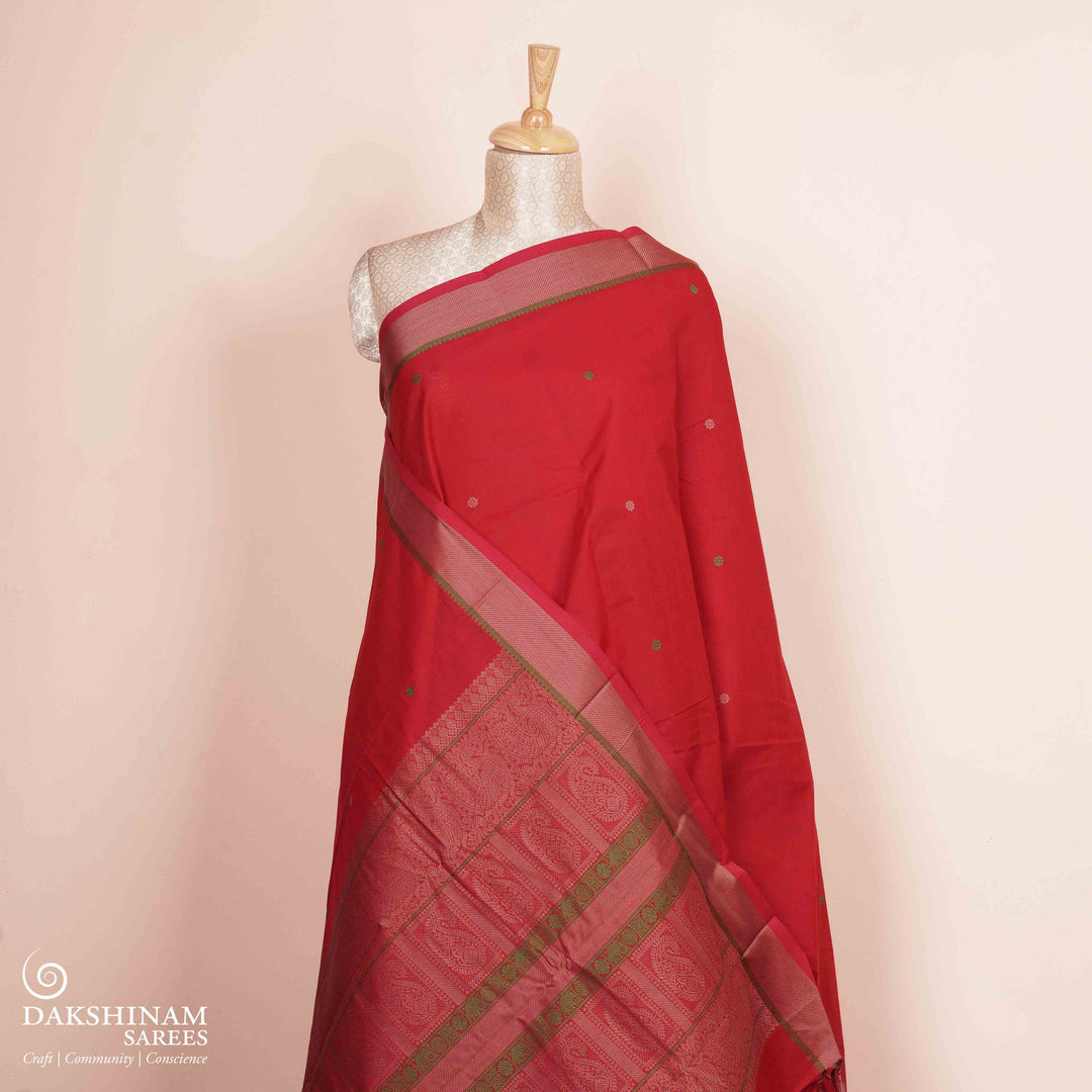 Red Kanchi cotton saree with chakram butta, diagonal border and rich traditional pallu with matching blouse