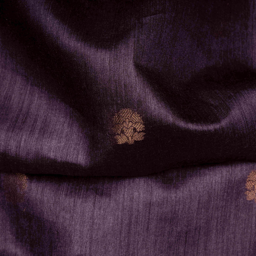 Close-up of purple fabric with a textured pattern and a small brown button.