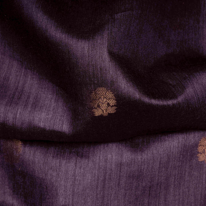 Close-up of purple fabric with a textured pattern and a small brown button.