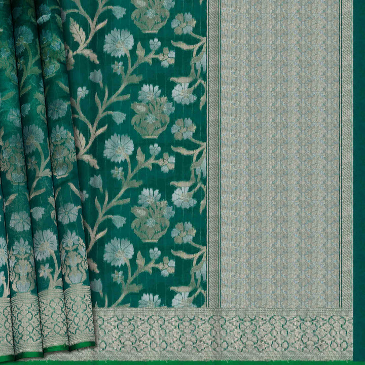 Green fabric with floral patterns and a geometric border