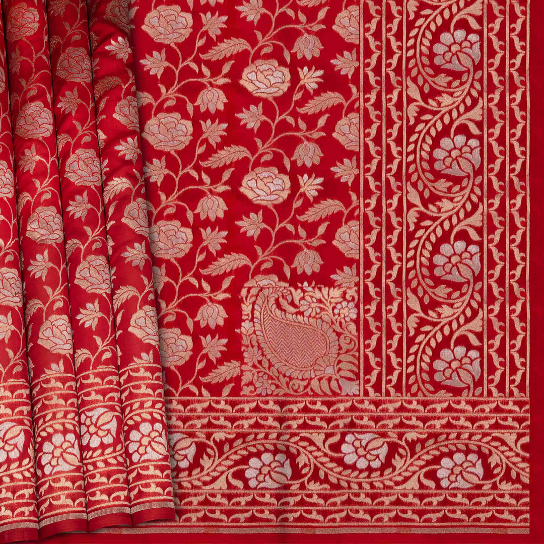 Red fabric with intricate white floral and leaf patterns