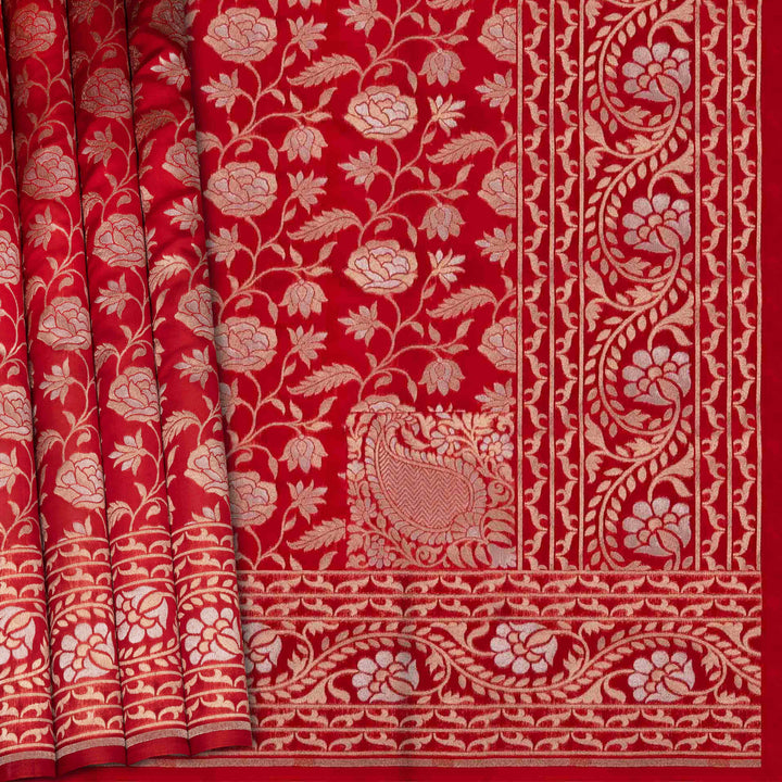 Red fabric with intricate white floral and leaf patterns