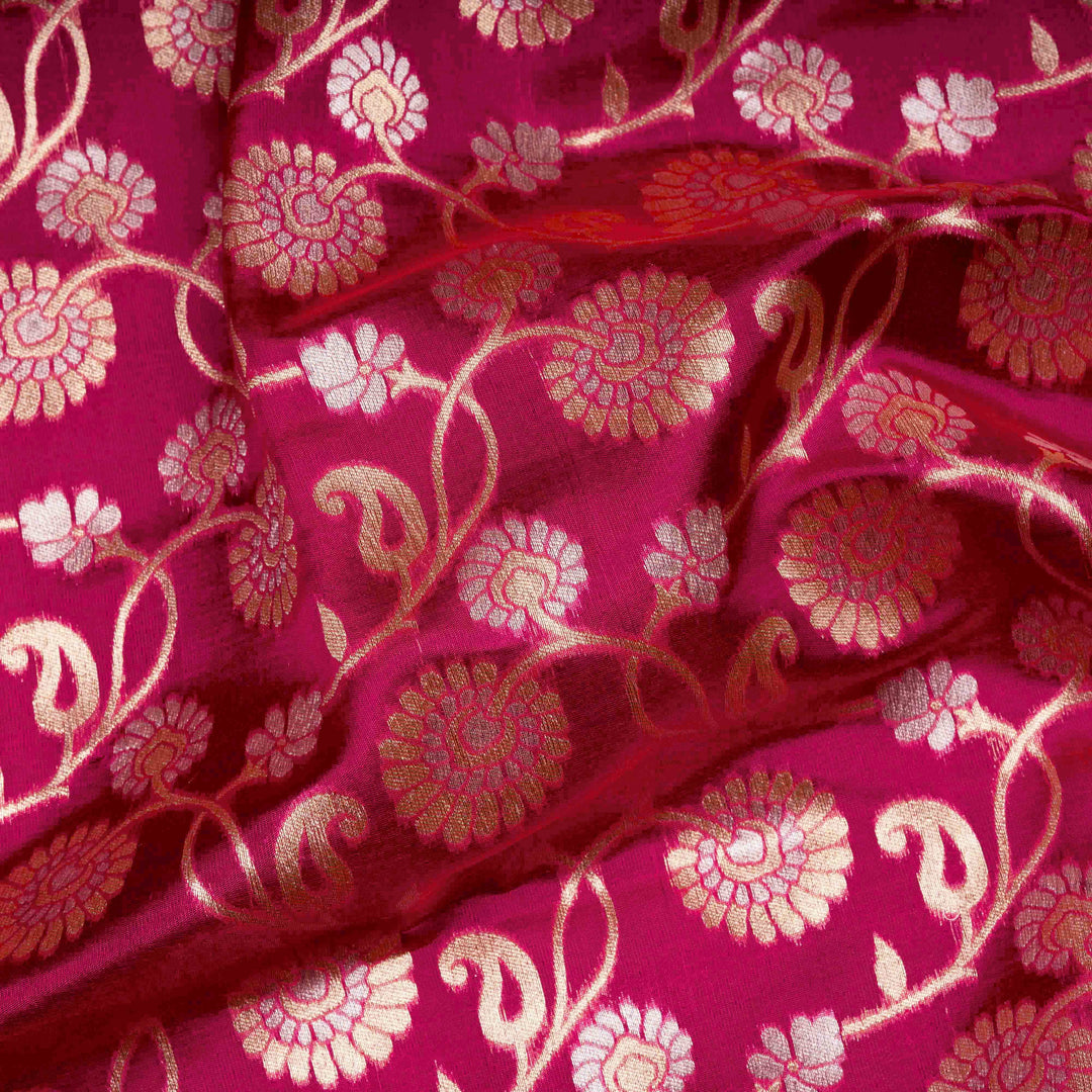 Close-up of pink fabric with gold floral patterns
