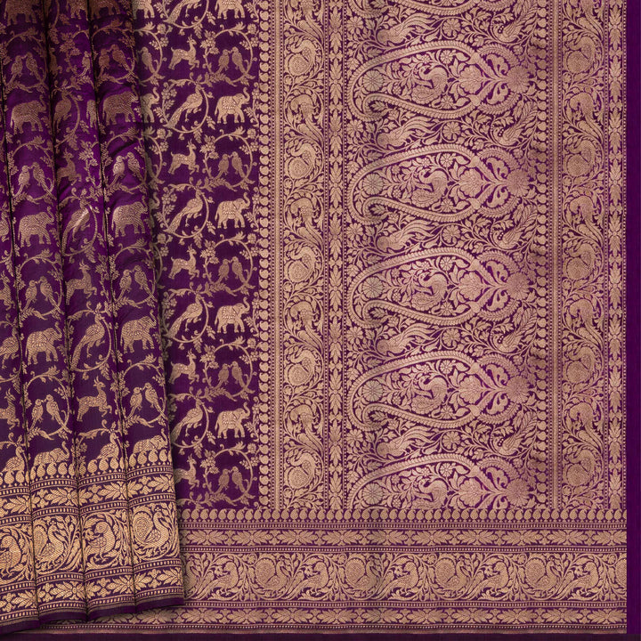 Purple fabric with intricate gold patterns and elephant designs