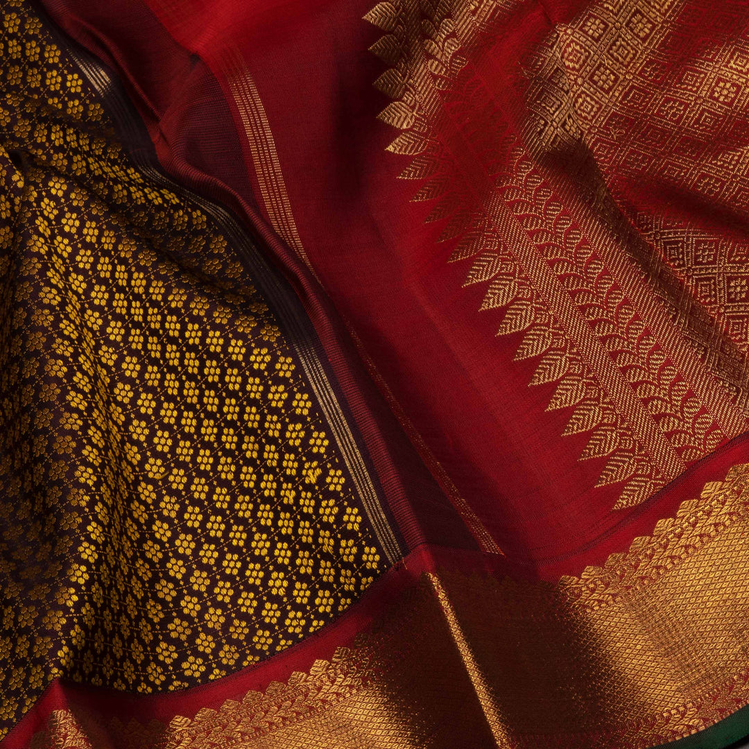Close-up of a red and gold saree with intricate patterns