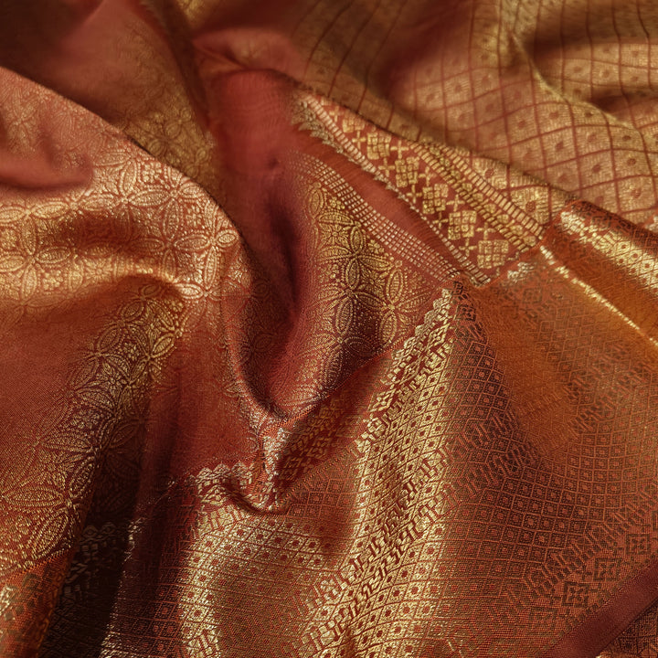 Close-up of brown fabric with intricate gold patterns