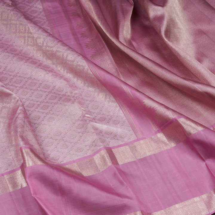 Close-up of a pink saree with a subtle pattern