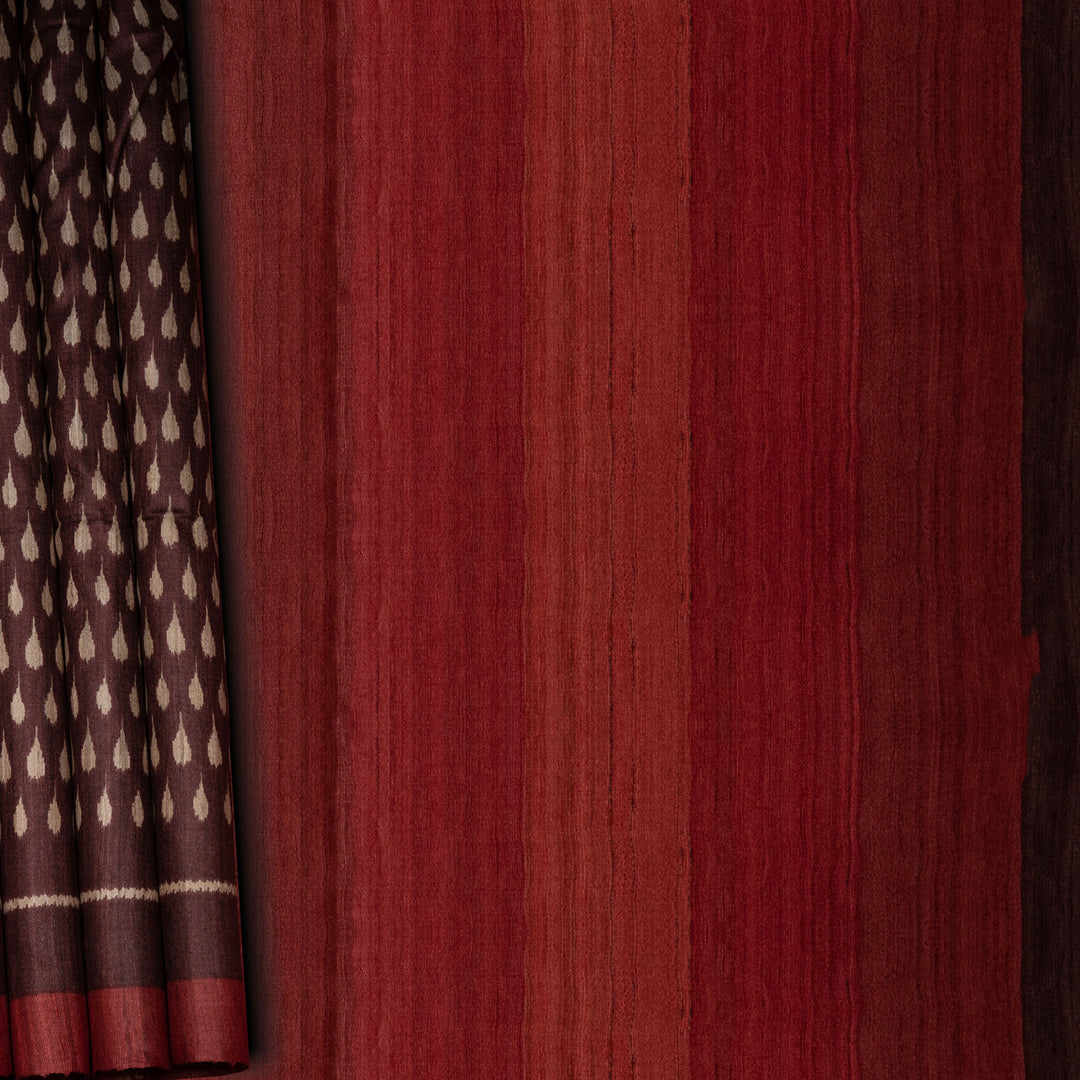 Close-up of maroon fabric with a subtle pattern on the left side.