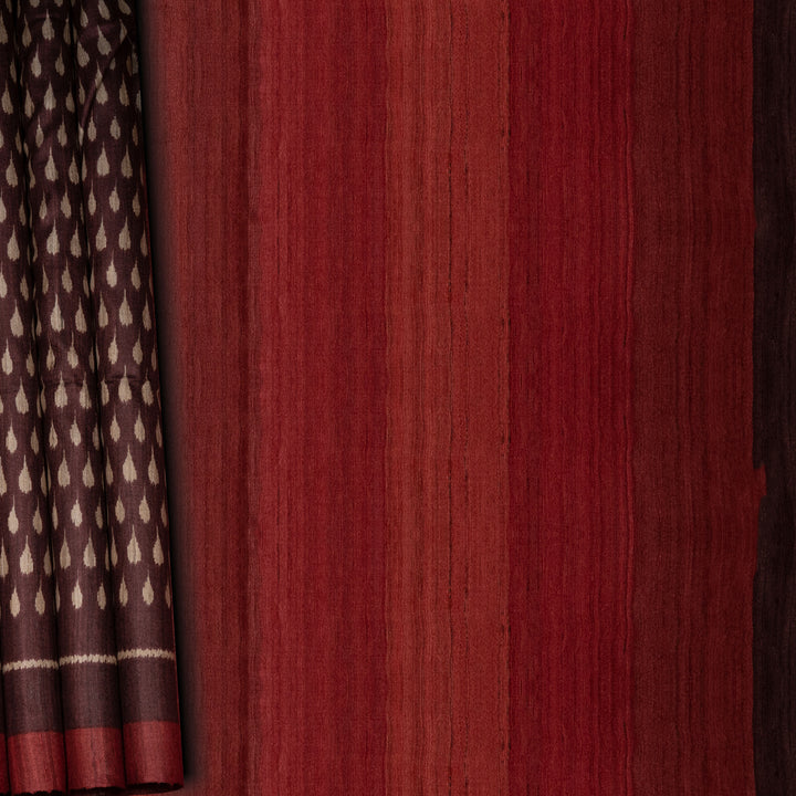 Close-up of maroon fabric with a subtle pattern on the left side.