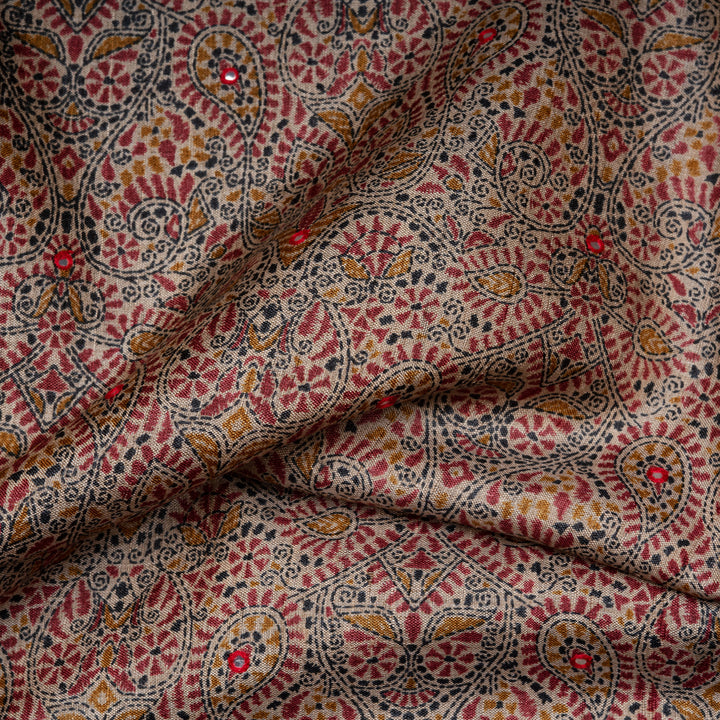 Close-up of patterned fabric with red, black, and gold colors.