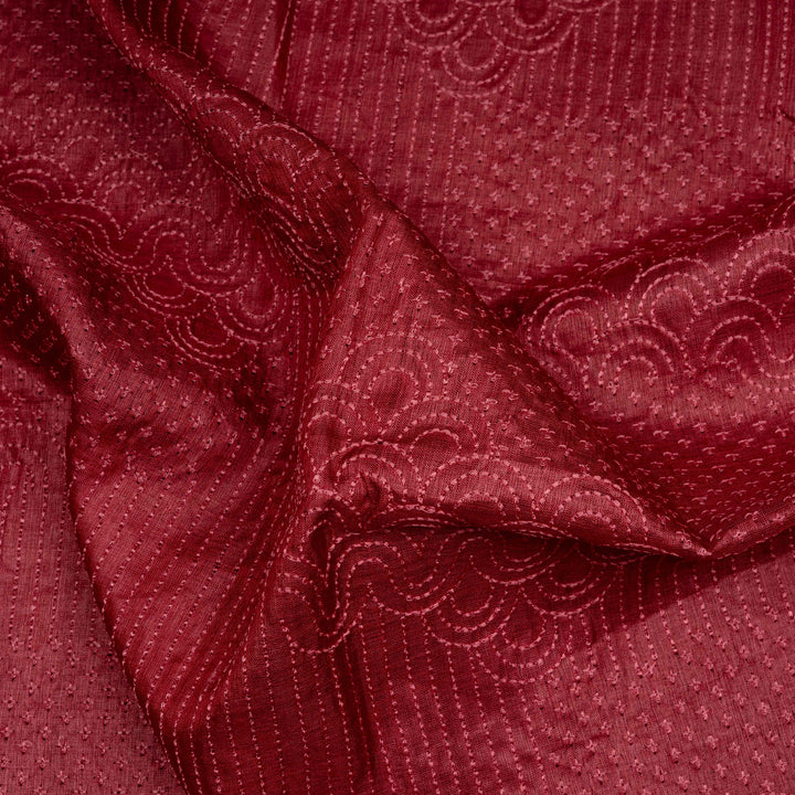 Close-up of red textured fabric with intricate patterns