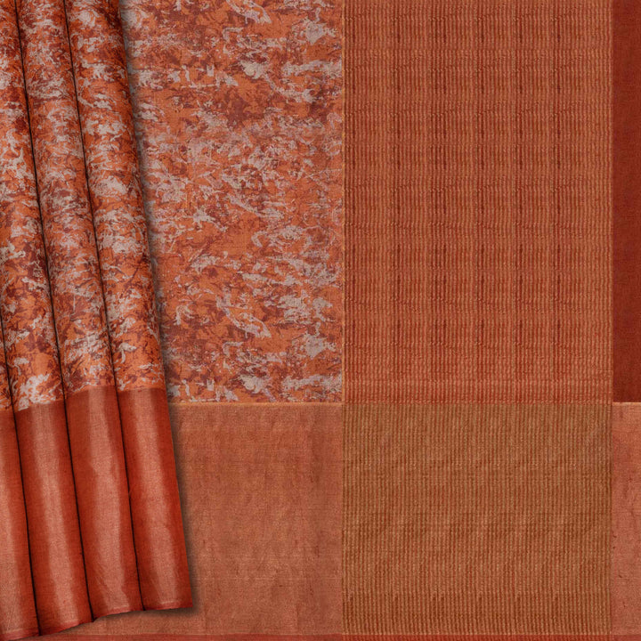 Close-up of a fabric with a textured pattern in shades of brown and orange.