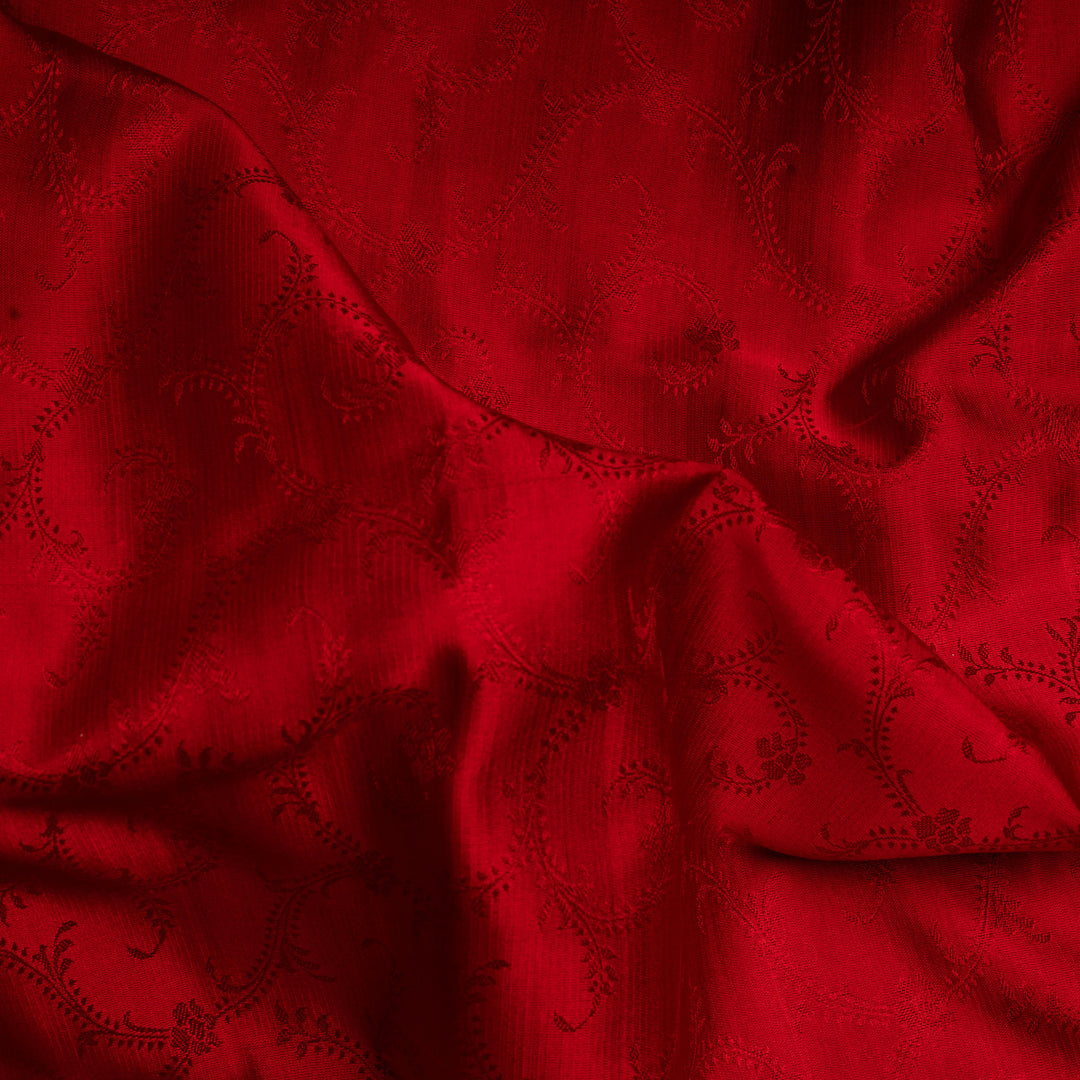 Close-up of red fabric with a subtle pattern