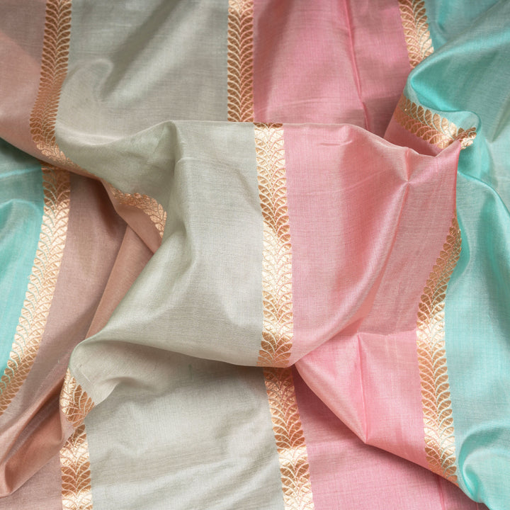 Close-up of colorful fabric with pastel shades on a gold patterned background
