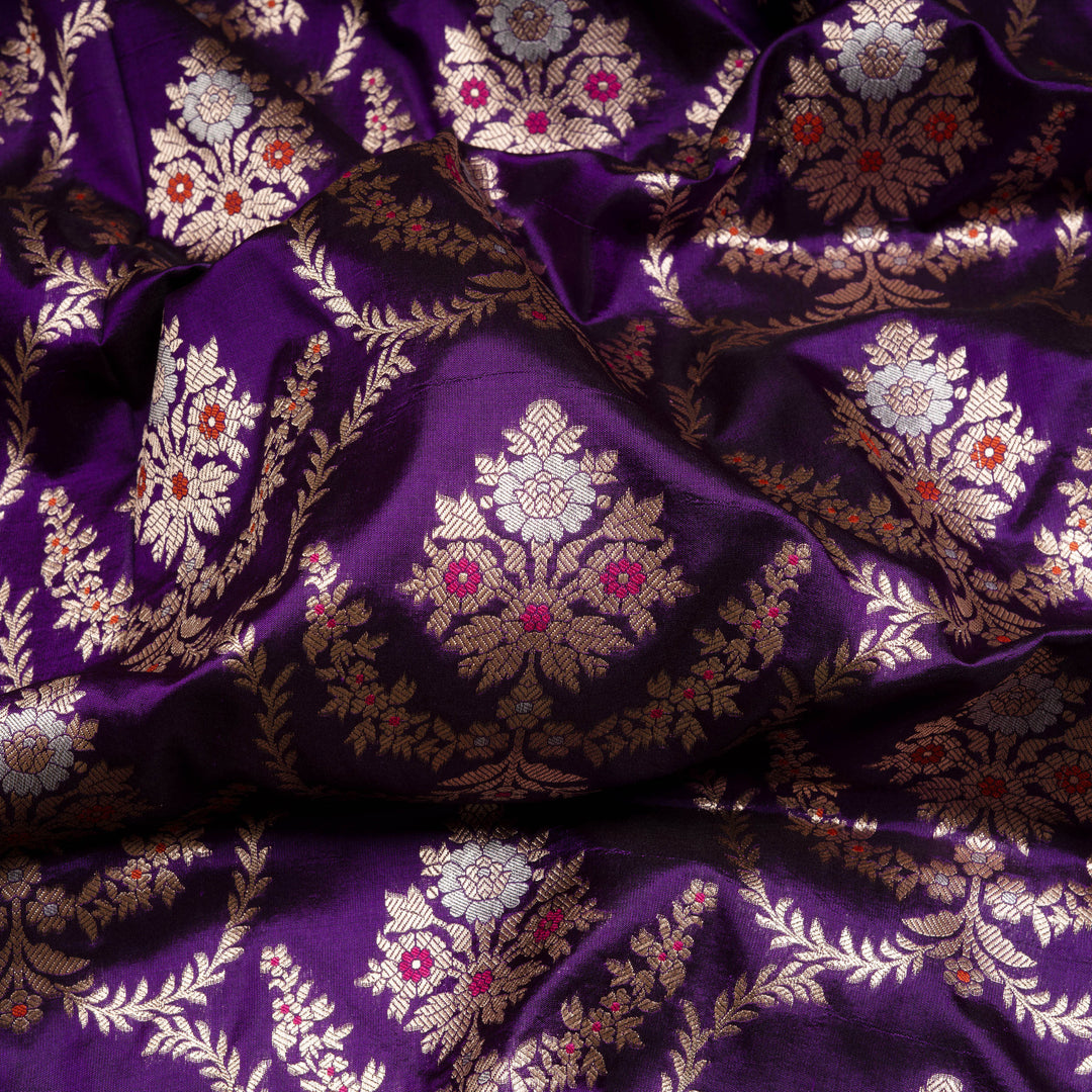 Close-up of purple fabric with intricate white and gold patterns