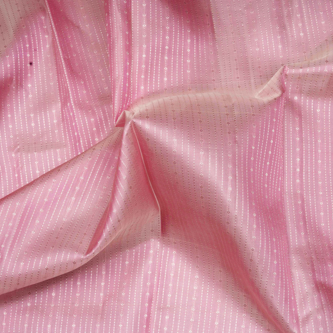 Close-up of pink fabric with a subtle pattern