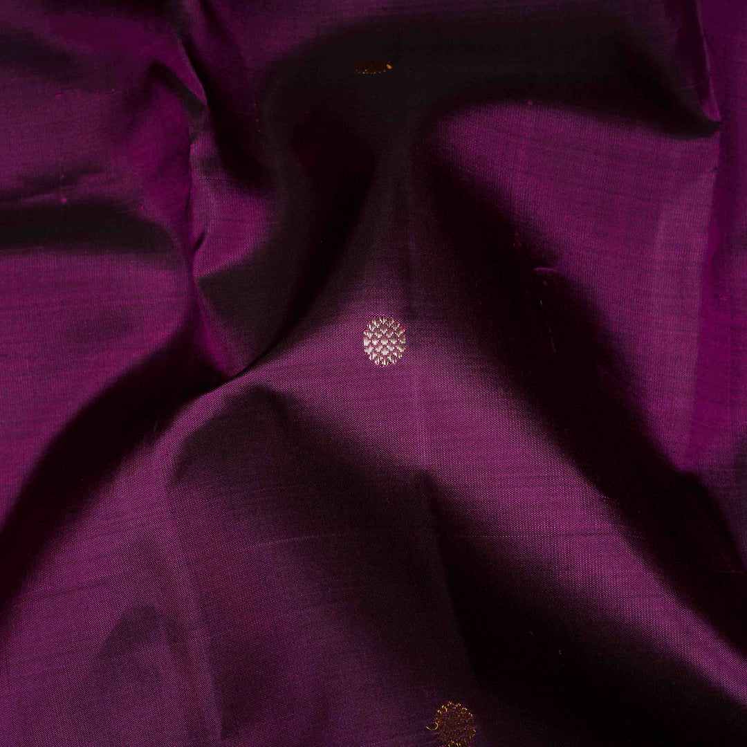 Close-up of purple fabric with a small embroidered design.