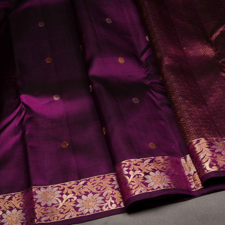 Purple fabric with gold and white floral patterns on a gray background
