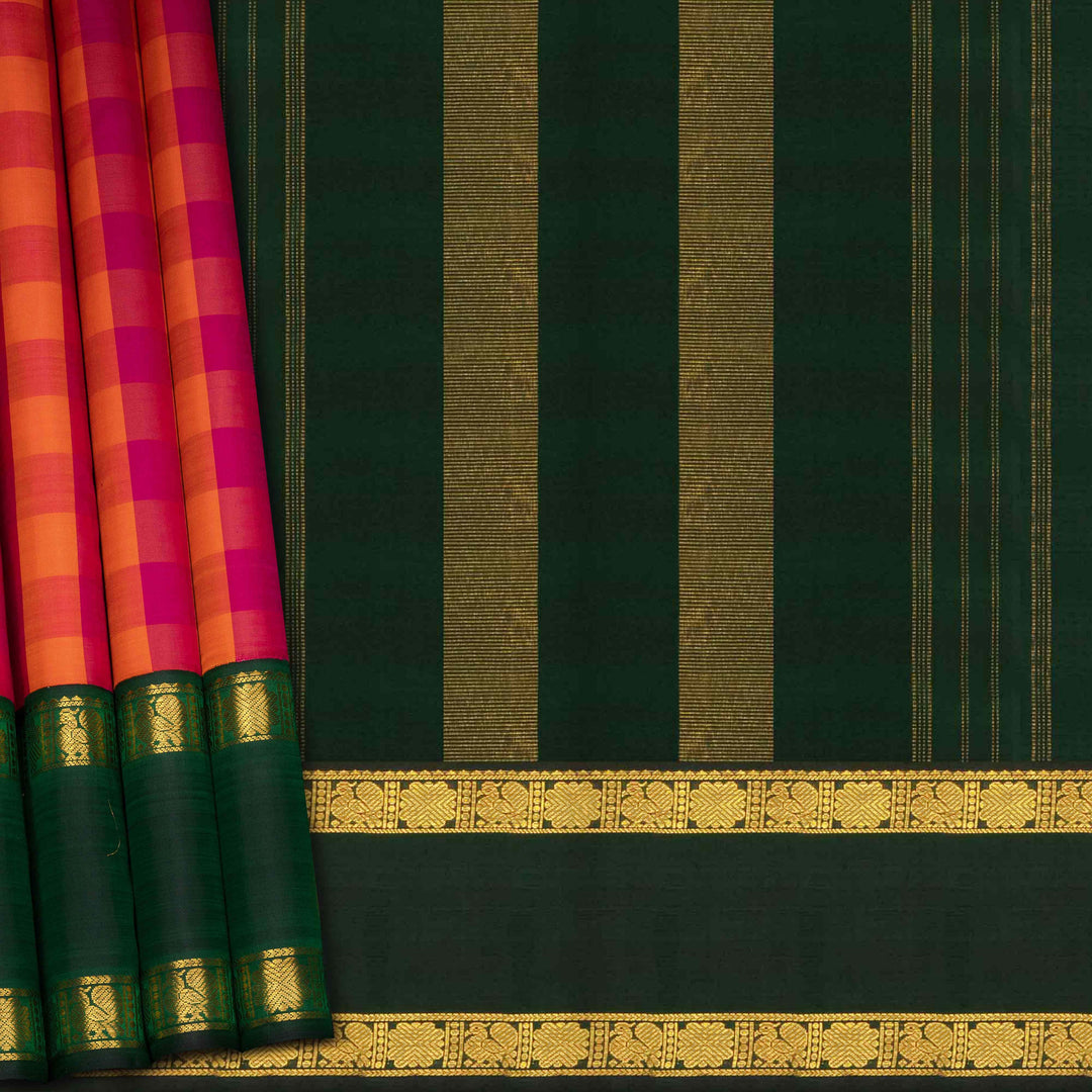 Green saree with gold border and pink and orange checkered pattern on the side