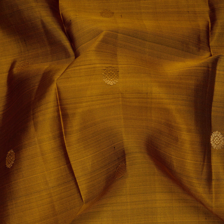 Close-up of yellow fabric with floral patterns, possibly a saree or fabric swatch.