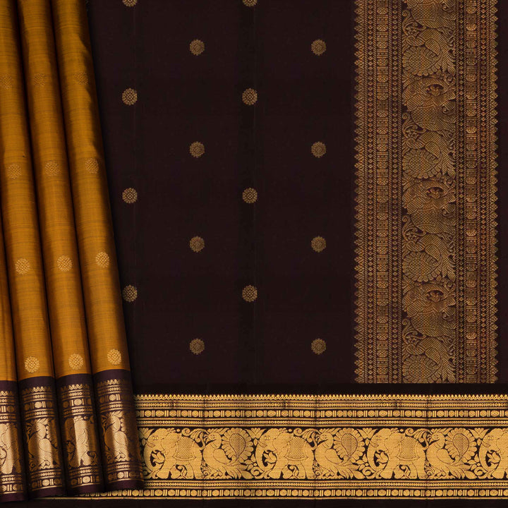 Dark purple saree with gold patterns and borders