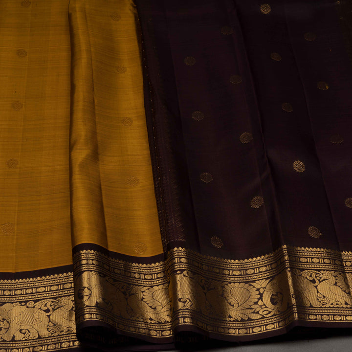 Sari with yellow and dark purple fabric, featuring intricate patterns.