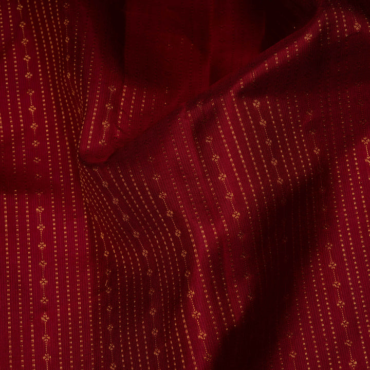 Close-up of a red fabric with gold patterns