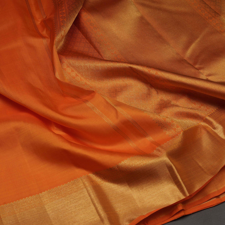 Close-up of orange fabric with a subtle pattern