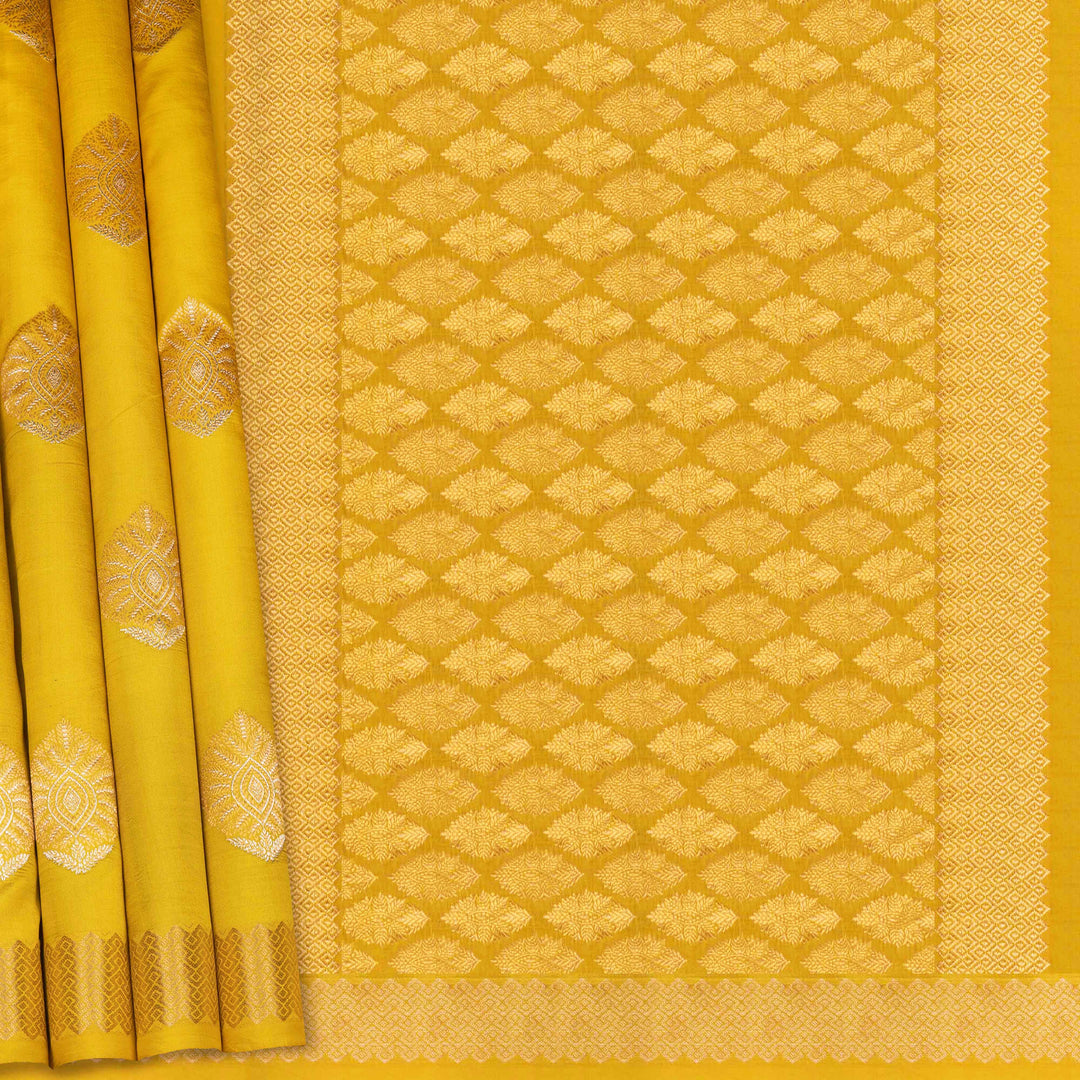 Yellow saree with intricate patterns on a plain background