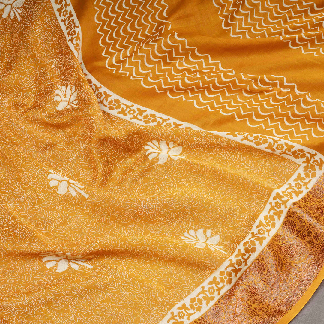 Close-up of a yellow fabric with white floral patterns and border