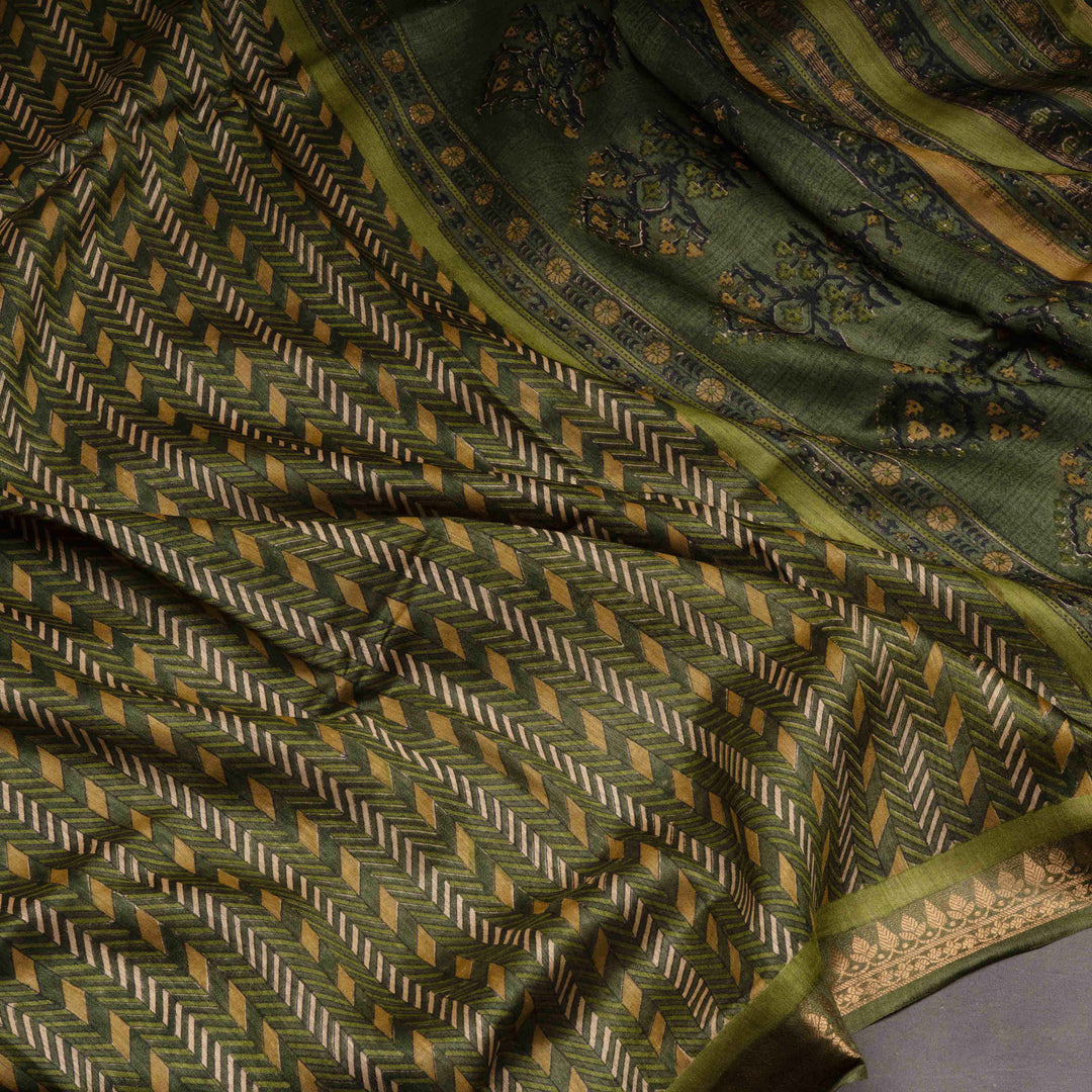 Close-up of a green patterned fabric with intricate designs.