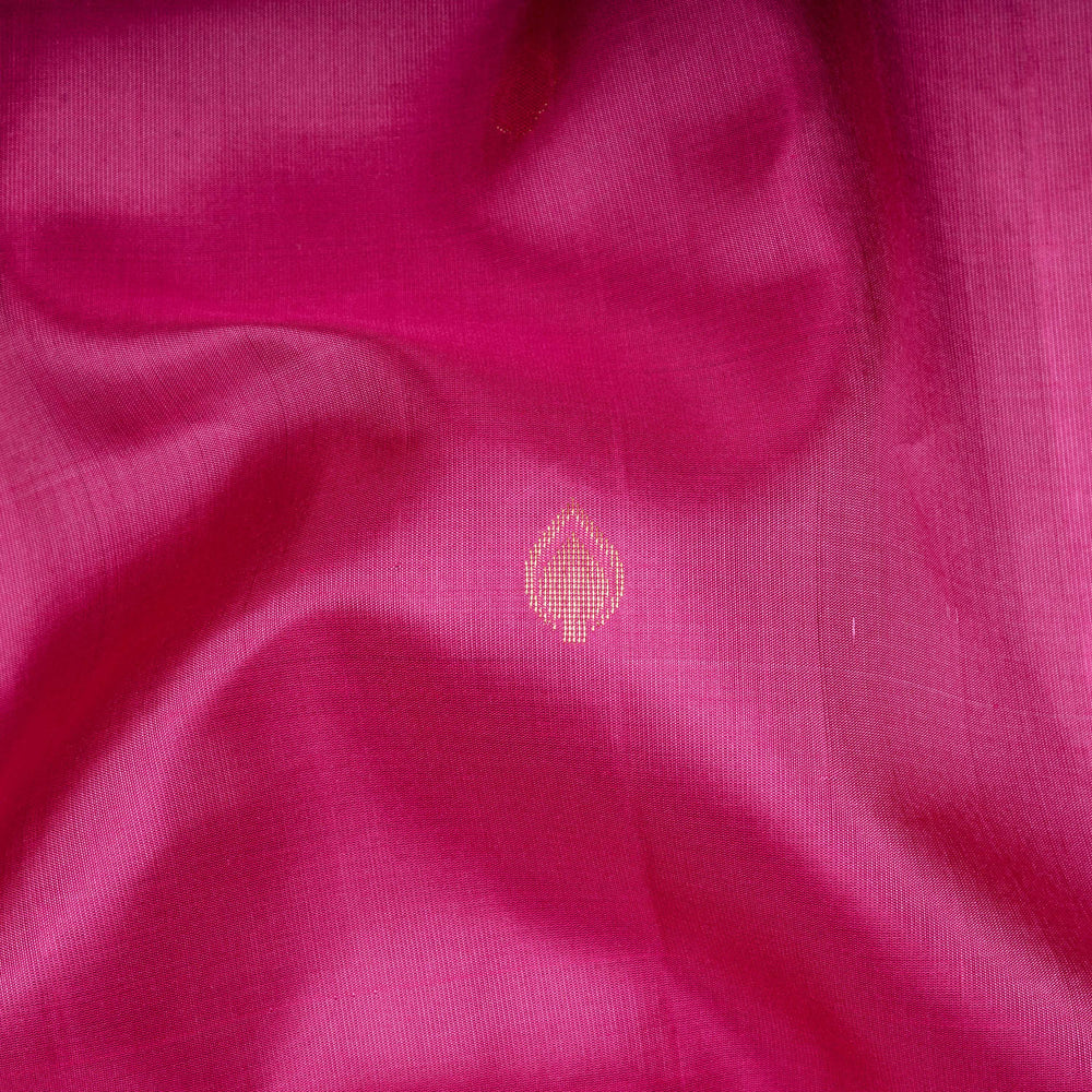 Close-up of pink fabric with a small embroidered design.