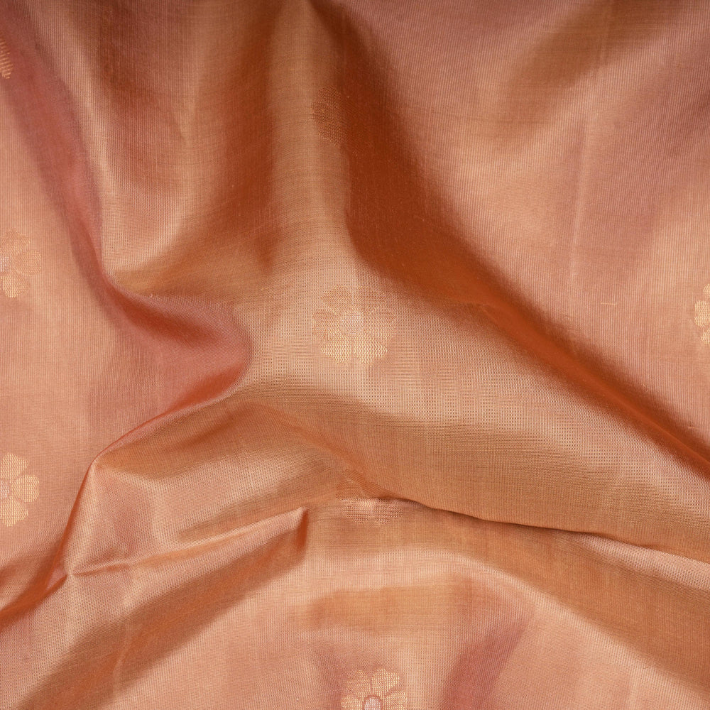 Close-up of peach-colored fabric with subtle patterns