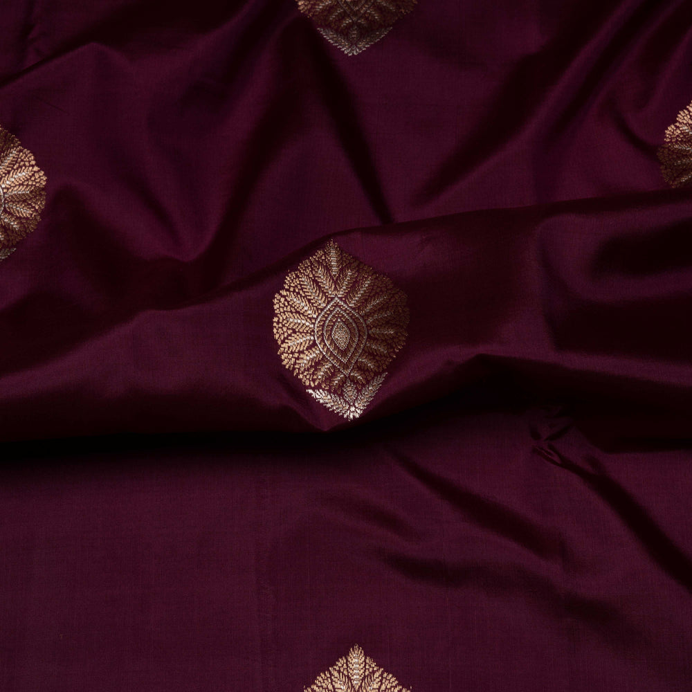 Close-up of dark purple fabric with gold embroidery