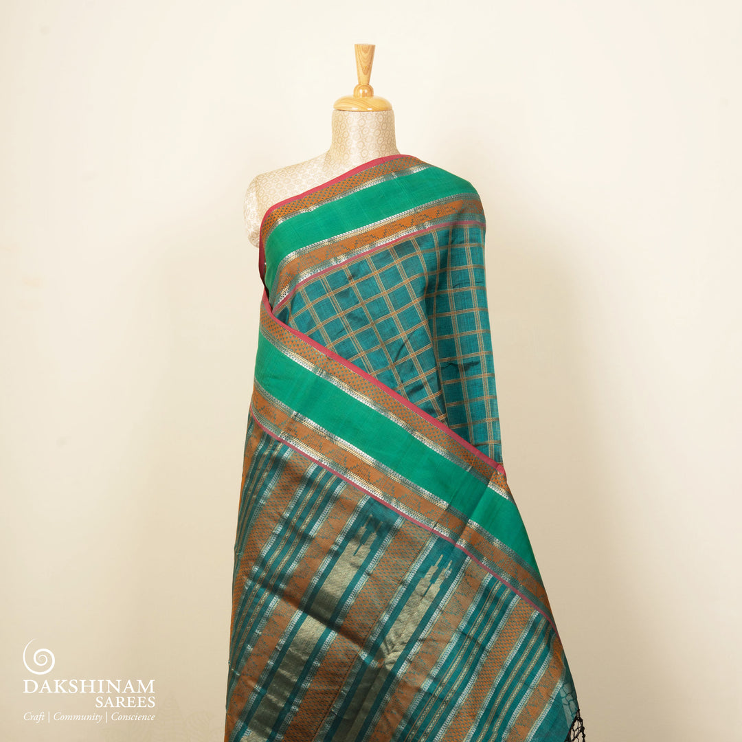 Checked dark green silk cotton saree with rettapet temple border and gold zari pallu design