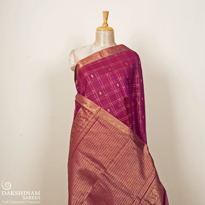 Magenta checked silk cotton saree with gold zari border featuring leaf motifs and dotted check pattern