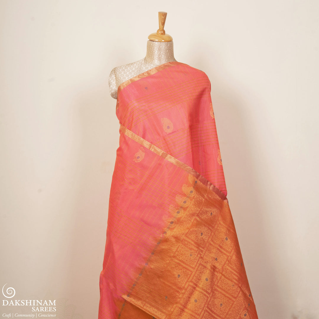 Peach silk cotton saree with paneled checks, mango butta, gold tissue border and orange floral pallu