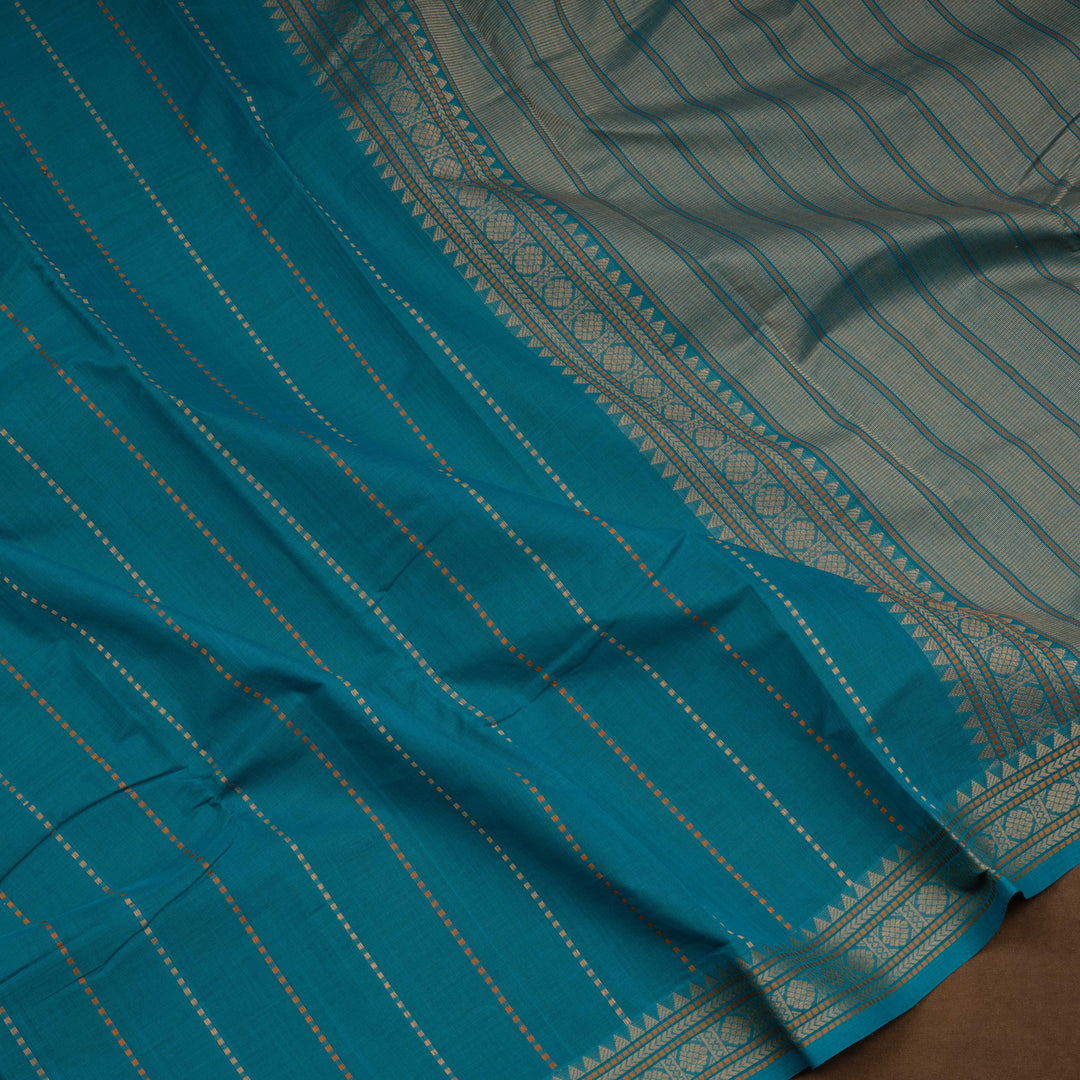 Teal blue handloom Kanchi cotton saree with striped dash butta body, traditional temple and vairom butta border, matching teal blouse.