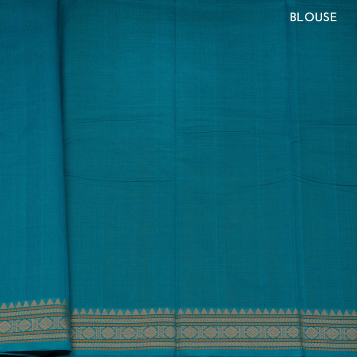 Teal blue handloom Kanchi cotton saree with striped dash butta body, traditional temple and vairom butta border, matching teal blouse.