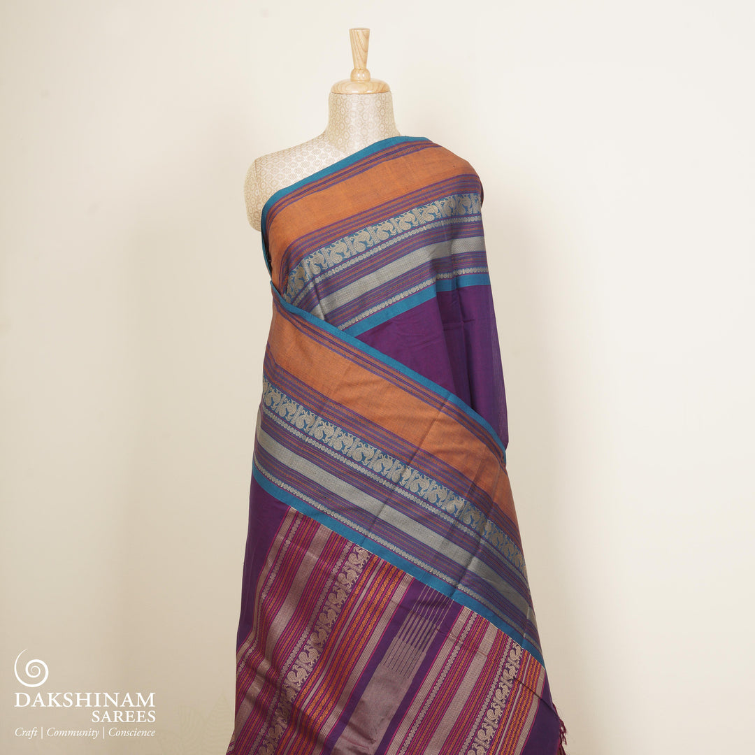 Purple Kanchi cotton saree with plain body, mango design border, mayil butta and traditional pallu with matching blouse