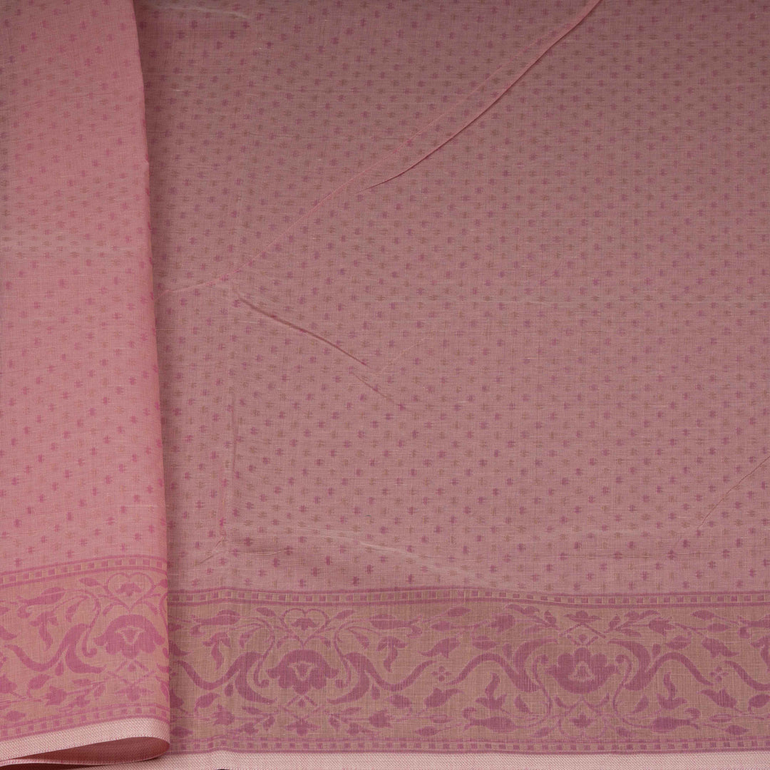 Pink South cotton saree with plant and paisley motifs across the body, floral border and peacock motif pallu, matching blouse with diamond butta design.
