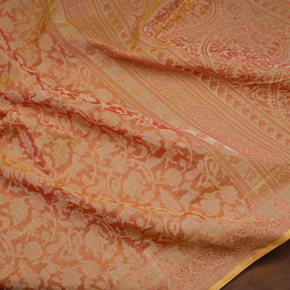 Orange South cotton saree with floral body featuring peacock, horse, elephant, deer and tiger motifs, traditional border and paisley pallu, matching blouse with dot design.