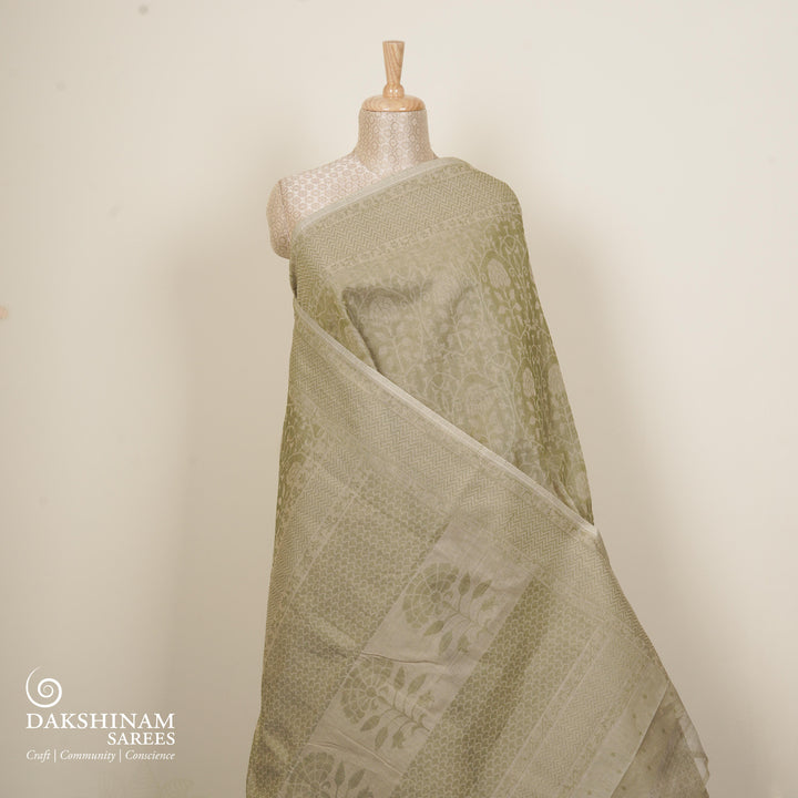 Beige South cotton saree with floral vine body pattern, vine border with chevron lines, patterned pallu and matching blouse with dot design.