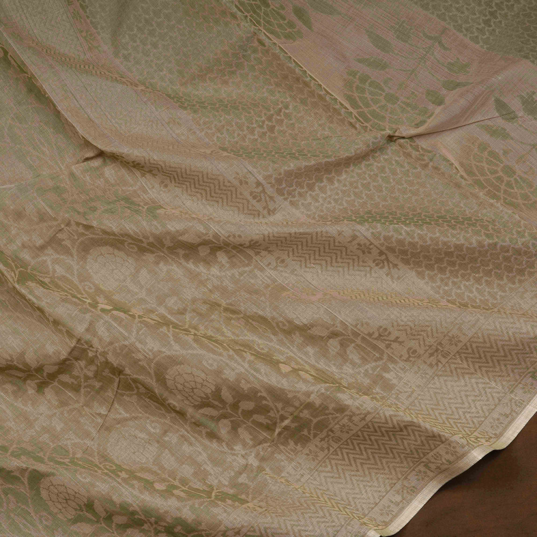 Beige South cotton saree with floral vine body pattern, vine border with chevron lines, patterned pallu and matching blouse with dot design.