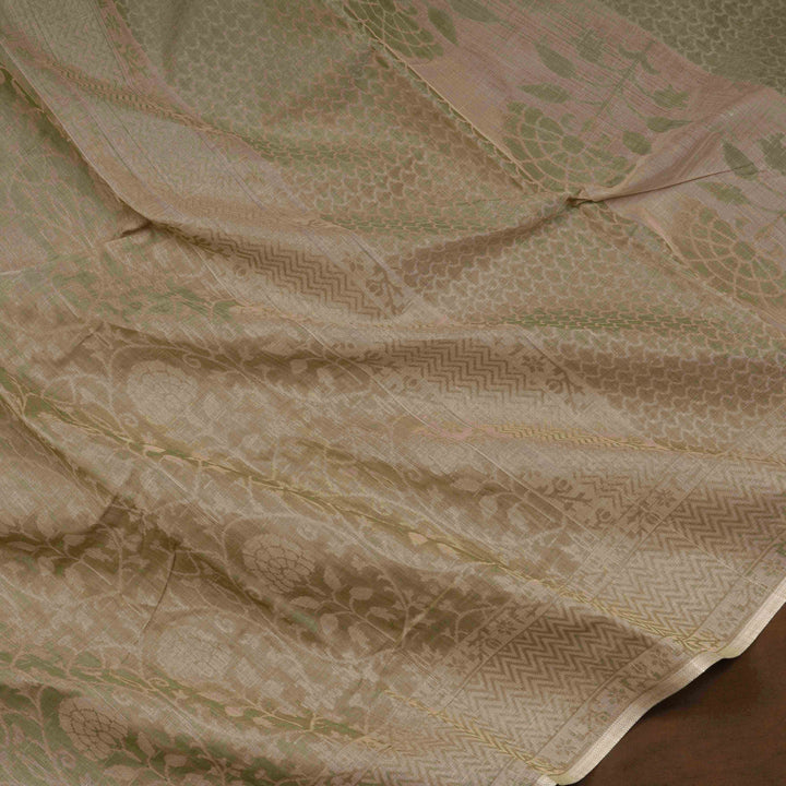 Beige South cotton saree with floral vine body pattern, vine border with chevron lines, patterned pallu and matching blouse with dot design.