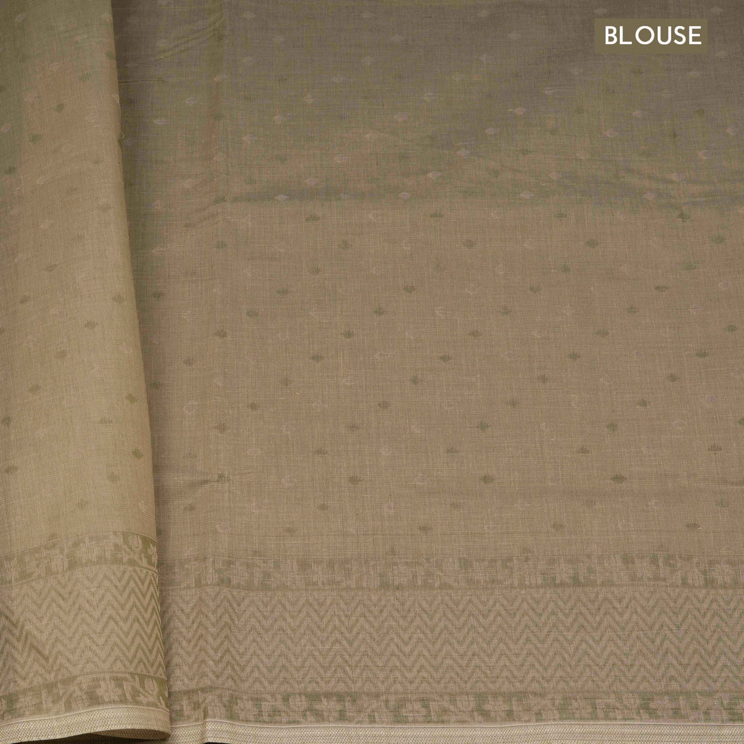 Beige South cotton saree with floral vine body pattern, vine border with chevron lines, patterned pallu and matching blouse with dot design.