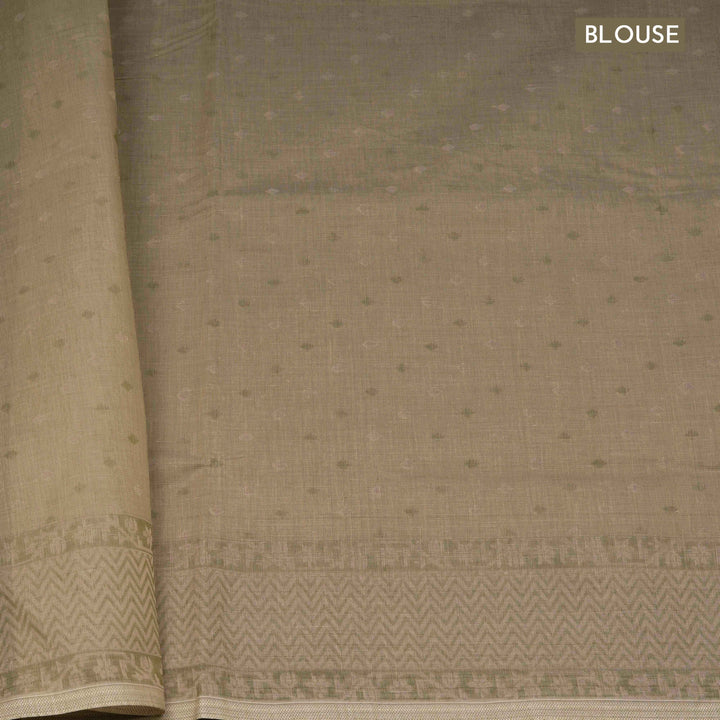 Beige South cotton saree with floral vine body pattern, vine border with chevron lines, patterned pallu and matching blouse with dot design.