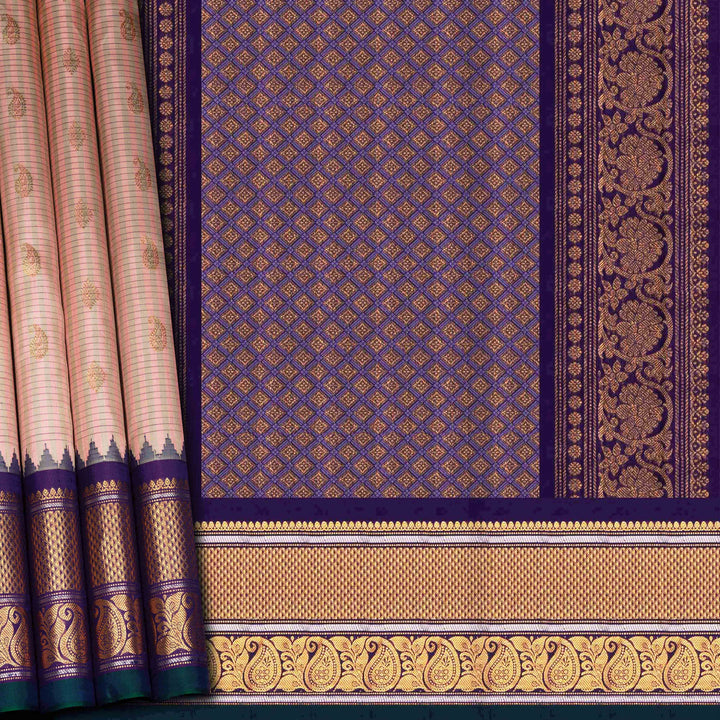 Peach Gadwal silk saree with grey checks and small butta body, purple zari border with mango and leaf motifs, plain purple blouse.